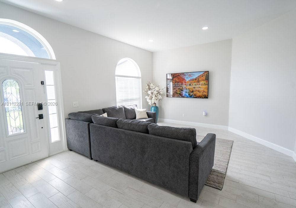 2461 Winfield, Kissimmee, FL 34743 Entryway featuring high ceilings, arched windows, recessed lighting, and light-toned tile flooring