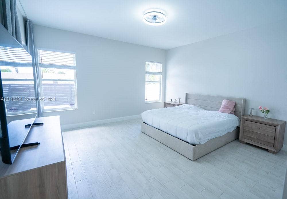 2461 Winfield, Kissimmee, FL 34743 Neutral-toned interior featuring wood-finish tile flooring, recessed window frames, and a contemporary flush-mount ceiling light fixture