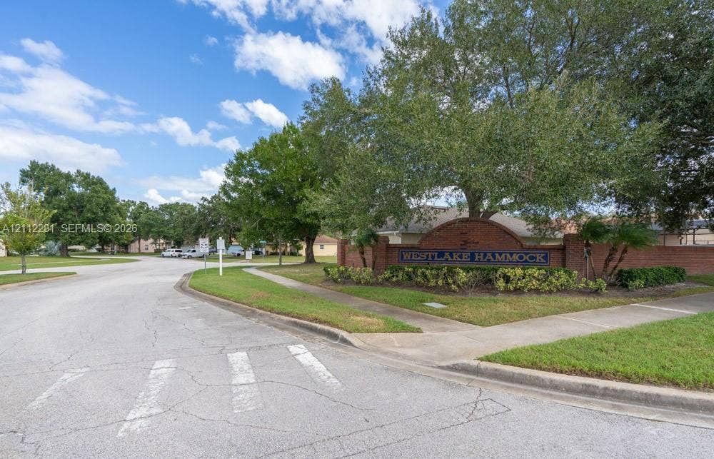 2461 Winfield, Kissimmee, FL 34743 Brick monument signage featuring decorative landscaping and mature oak trees