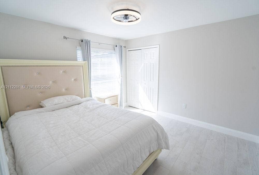 2461 Winfield, Kissimmee, FL 34743 Neutral wall tones, wood-finish flooring, double-panel closet doors, and a low-profile integrated ceiling light fixture