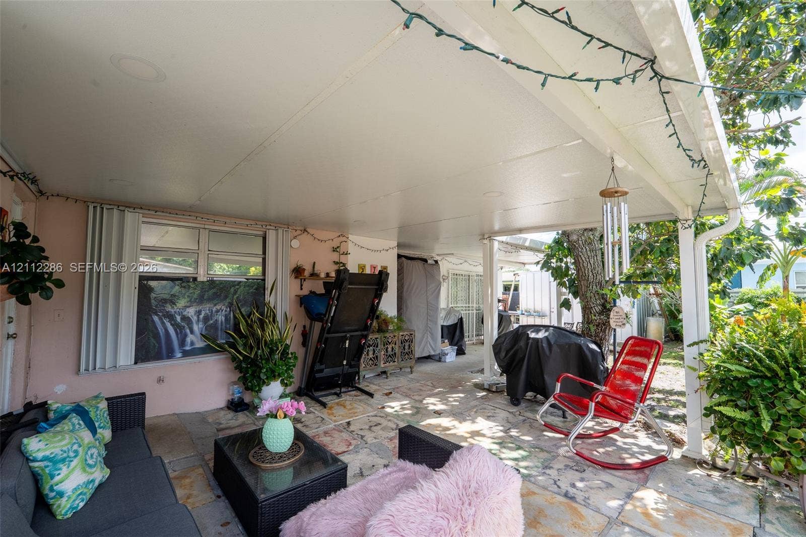 Covered patio featuring a solid-surface ceiling, recessed lighting, and multi-tone stone flooring