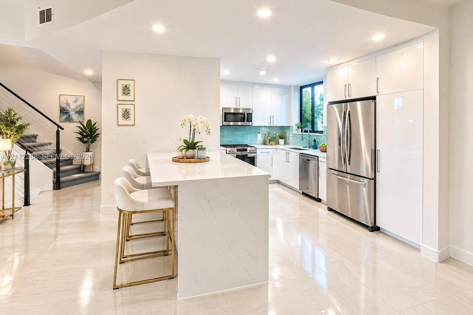 Kitchen featuring flat-panel white cabinetry, stone-finish countertops, stainless steel appliances, a center island with counter seating, and recessed lighting