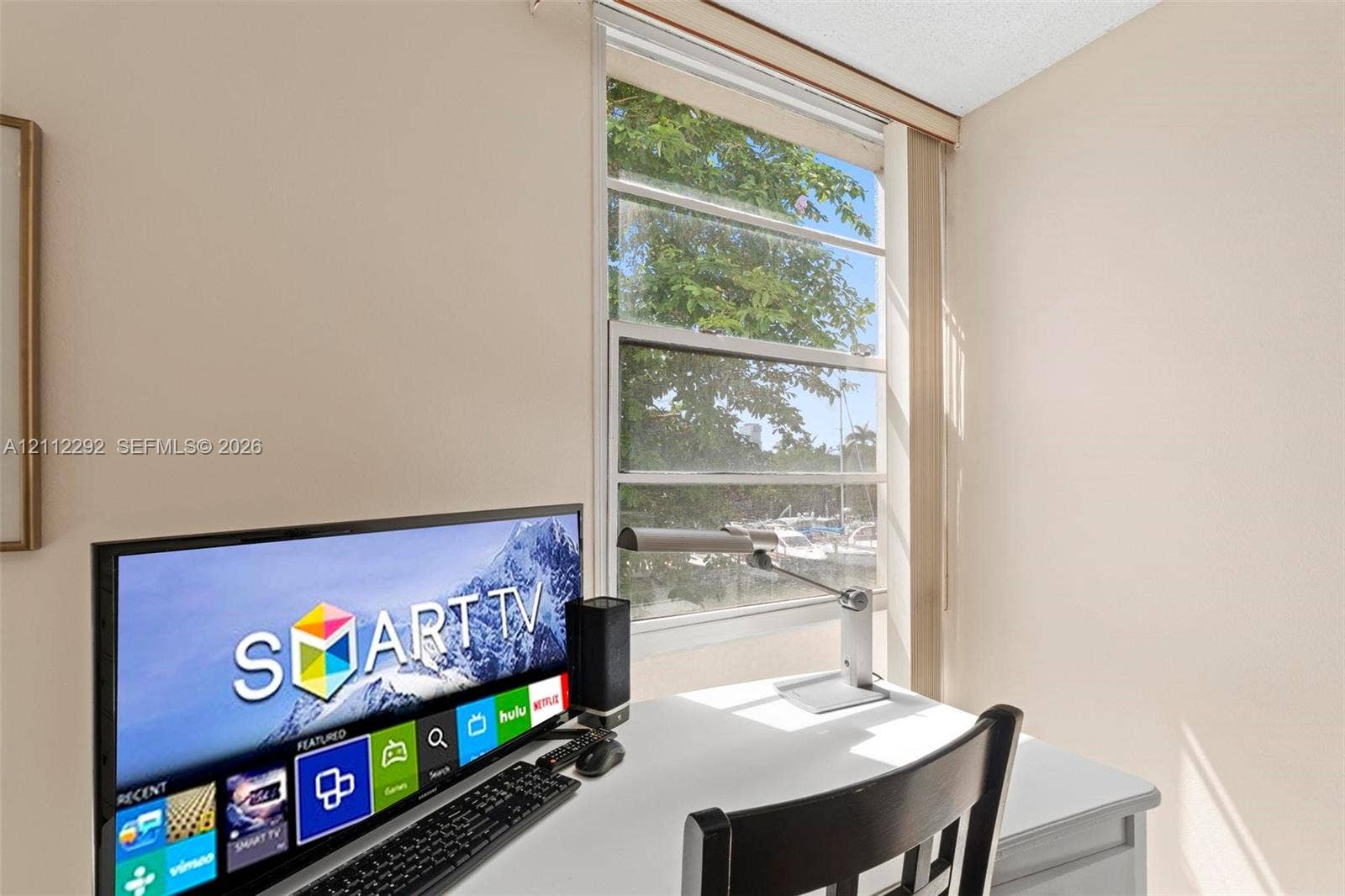 Vertical sliding window with neutral-toned vertical blinds