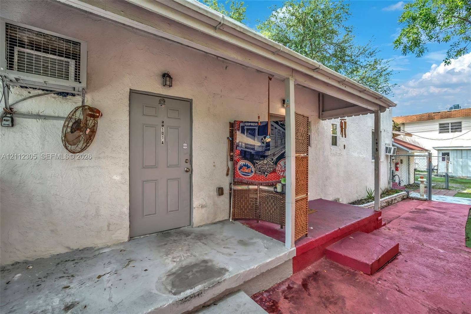 1008 N 18th Court, Hollywood, FL 33020 Stucco exterior featuring a covered porch, recessed exterior lighting, and painted concrete hardscaping