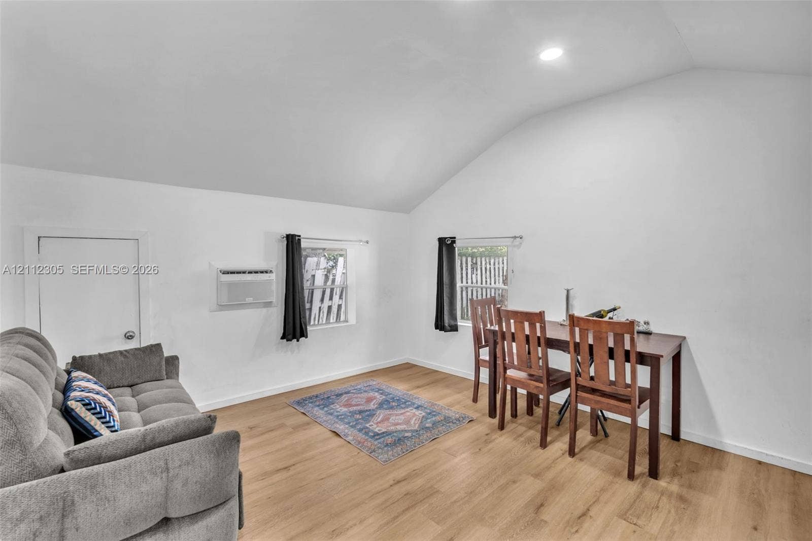 1008 N 18th Court, Hollywood, FL 33020 Vaulted ceiling, wood-finish flooring, recessed lighting, and wall-mounted air conditioning unit