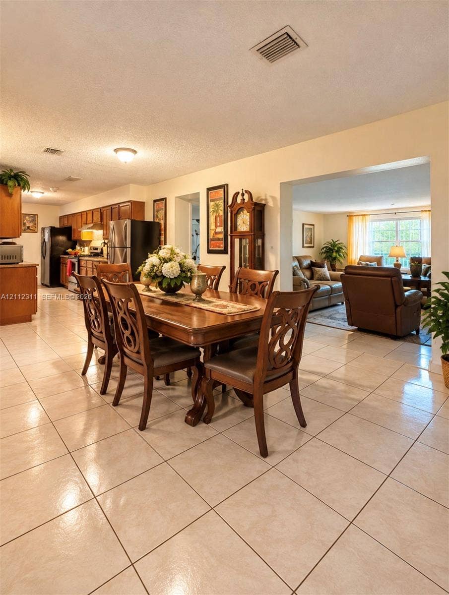 390 NW 49th Avenue, Plantation, FL 33317 Tile flooring throughout the main living areas, kitchen cabinetry with neutral countertops, and recessed ceiling lighting