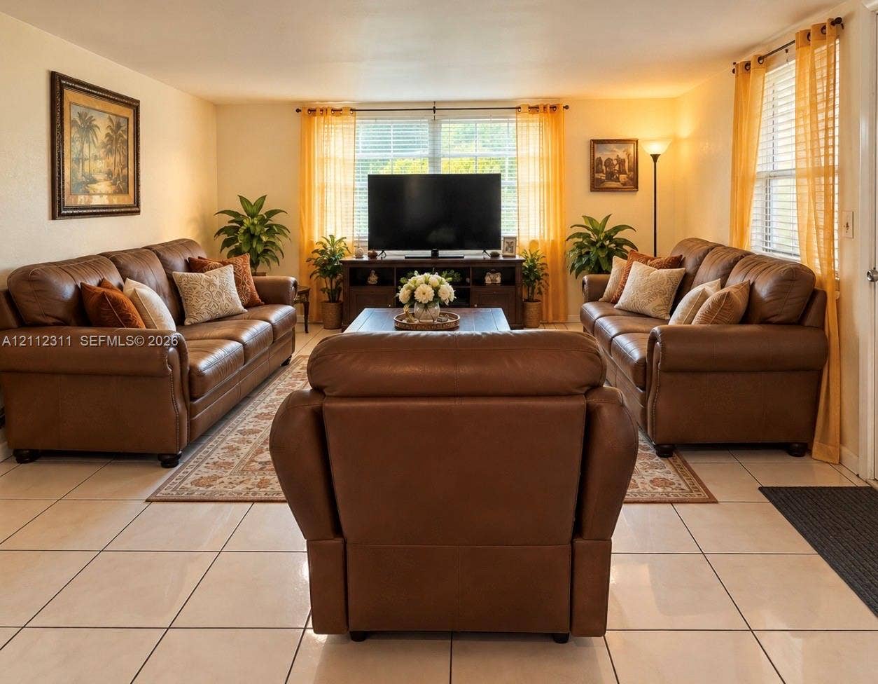 390 NW 49th Avenue, Plantation, FL 33317 Large-format neutral tile flooring and natural light through multiple windows