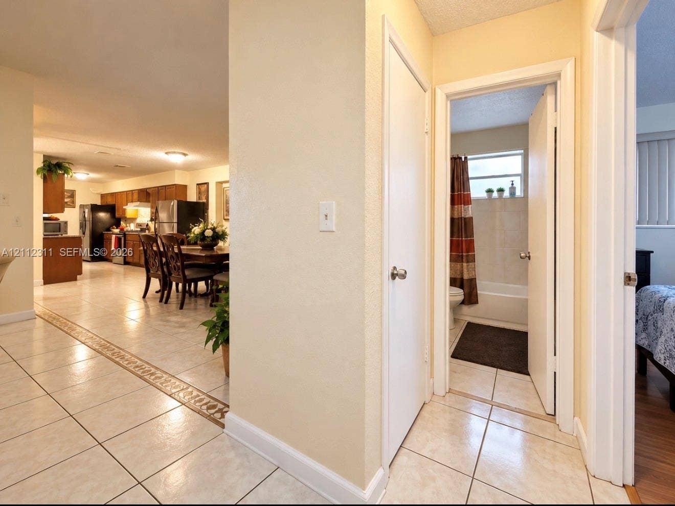 390 NW 49th Avenue, Plantation, FL 33317 Ceramic tile flooring with decorative inlay, flush-mount lighting, and neutral wall tones