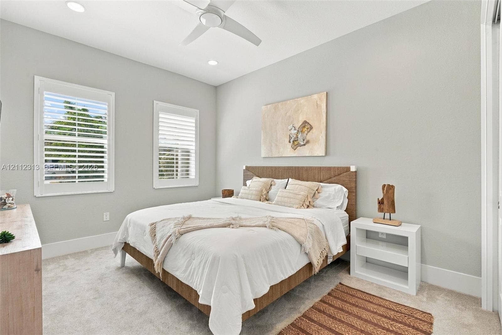 Bedroom featuring neutral wall paint, recessed lighting, carpeted flooring, and two windows equipped with white plantation shutters and a ceiling fan