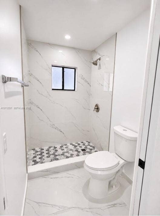 Full-height shower surround featuring large-format veined tile, contrasting hexagonal floor tile, brushed nickel fixture, and recessed lighting