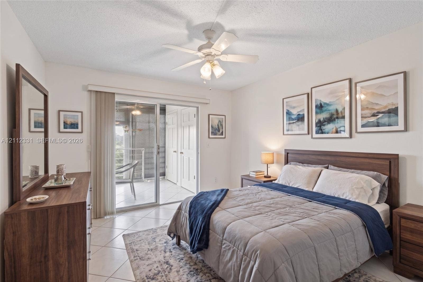 4025 Upminster K, #4025, Deerfield Beach, FL 33442 Neutral-toned tile flooring, white ceiling fan with integrated lighting, and glass sliding doors providing exterior access