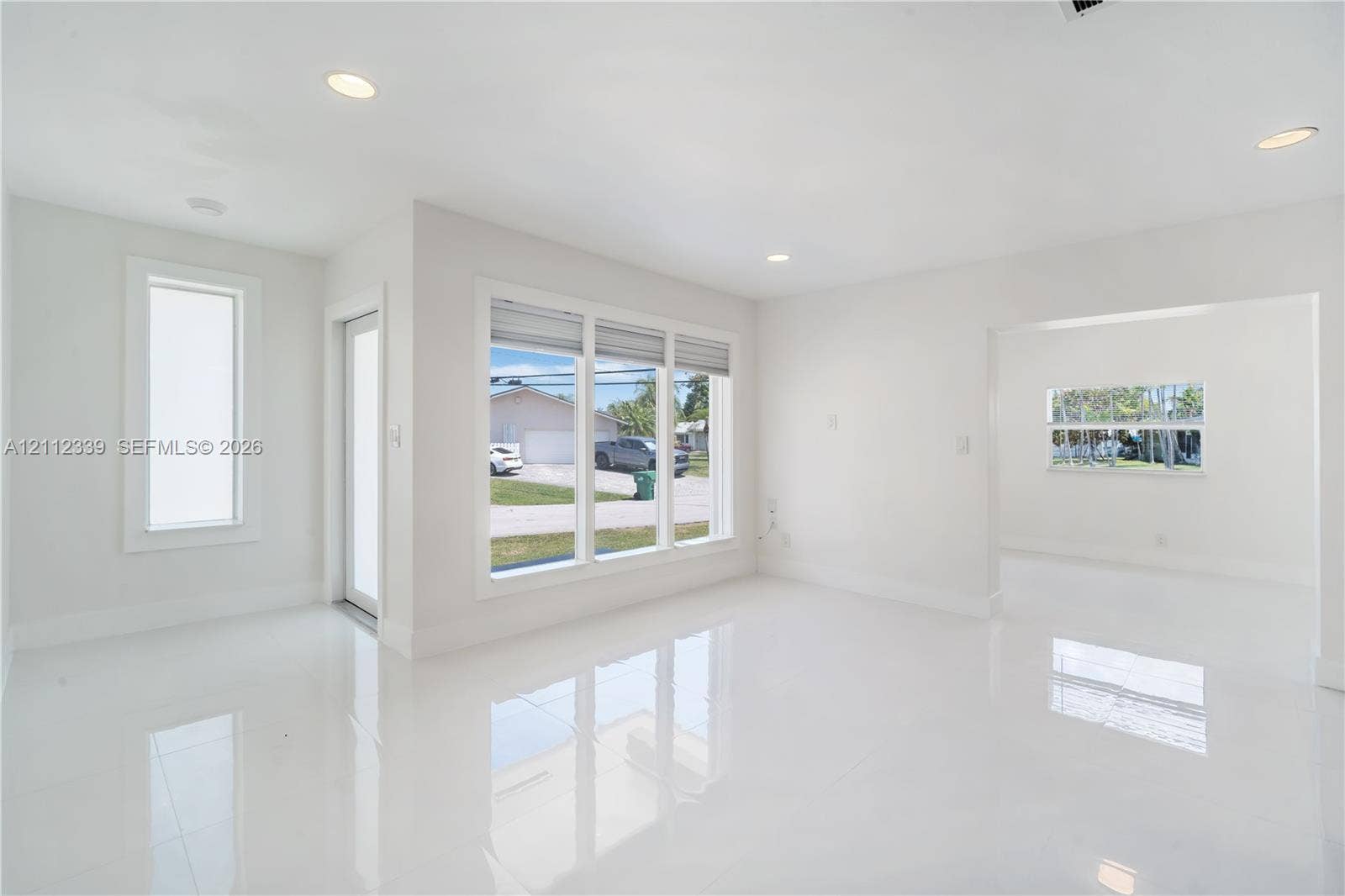 8901 SW 149th Terrace, #n/a, Palmetto Bay, Palmetto Bay, FL 33176 Large-format white tile flooring, recessed ceiling lighting, and expansive windows with natural light exposure