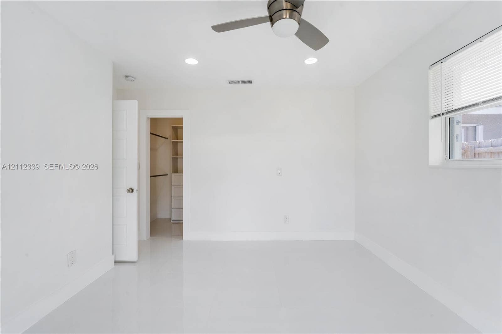8901 SW 149th Terrace, #n/a, Palmetto Bay, Palmetto Bay, FL 33176 Interior space featuring smooth-finish flooring, recessed lighting, a brushed-nickel ceiling fan, and a walk-in closet with built-in shelving
