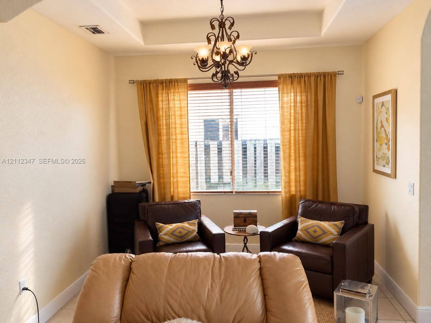 8766 NW 139th Terrace, #139, Miami Lakes, Miami Lakes, FL 33018 Interior space featuring a recessed tray ceiling, wrought-iron chandelier, and horizontal window blinds