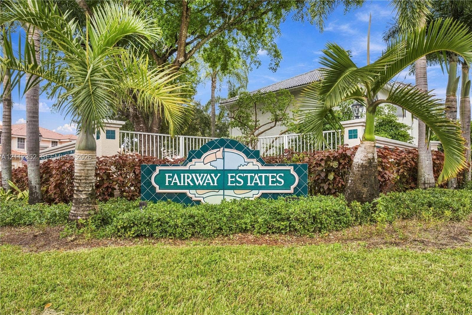 2880 NW 75th Avenue, Margate, FL 33063 Community monument sign featuring decorative masonry, perimeter fencing, lush landscaping, and mature palms