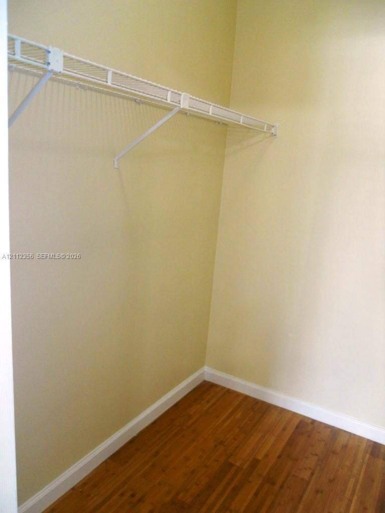 Storage area featuring wood-finish flooring and white wire shelving