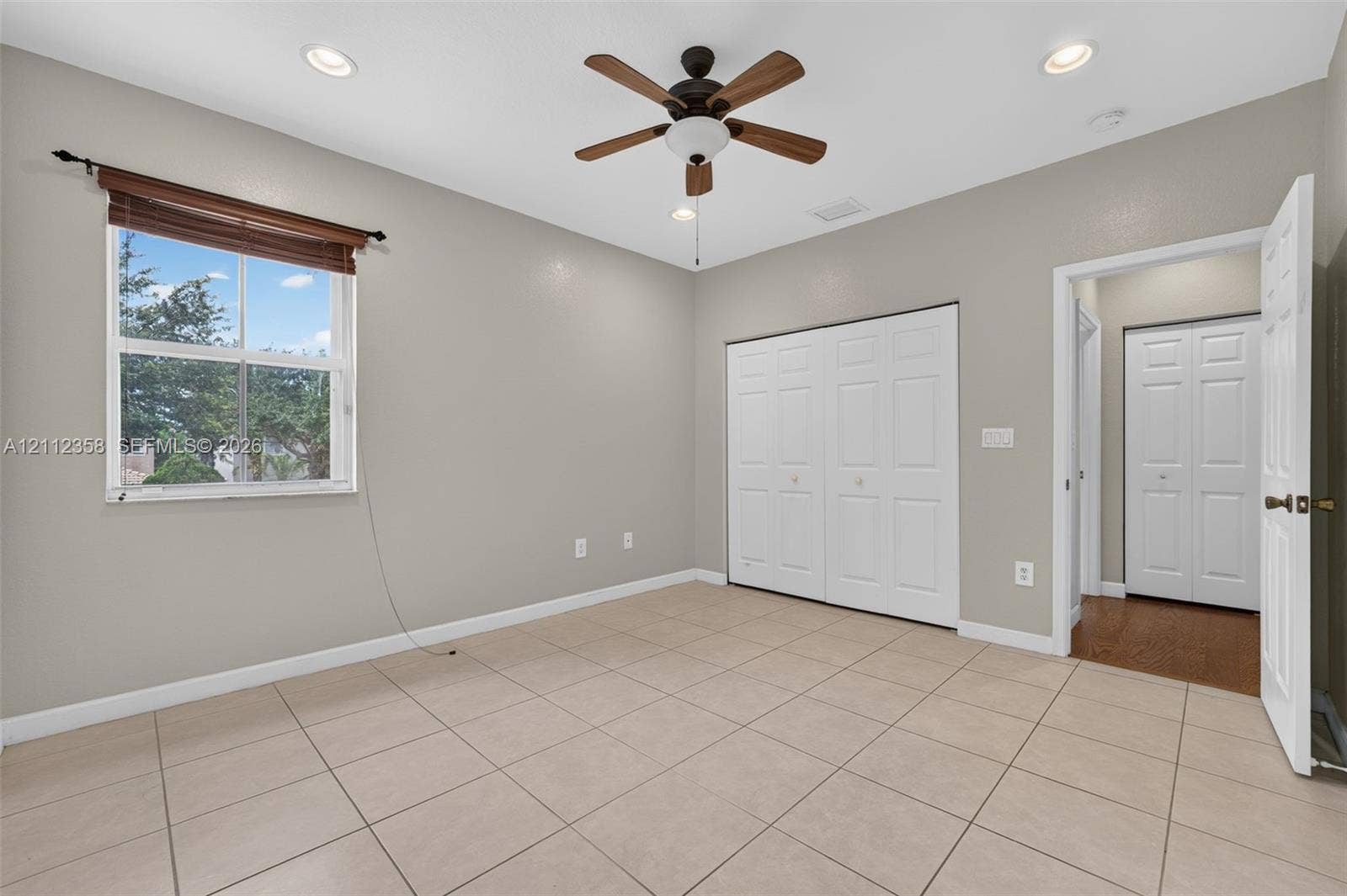 1611 SE 16th Street, Homestead, FL 33035 Room featuring tile flooring, neutral wall paint, recessed lighting, a ceiling fan with integrated light fixture, and double-panel closet doors