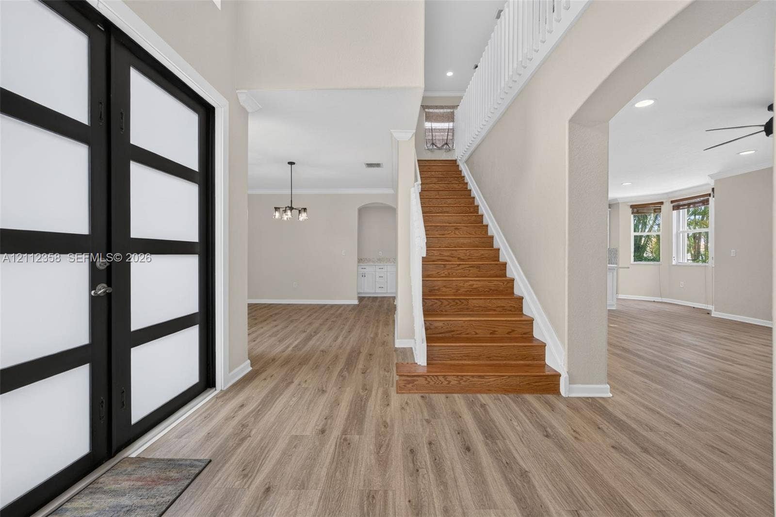 1611 SE 16th Street, Homestead, FL 33035 Double entry with frosted glass panels, wood-finish flooring, staircase with natural wood treads, and white balustrade