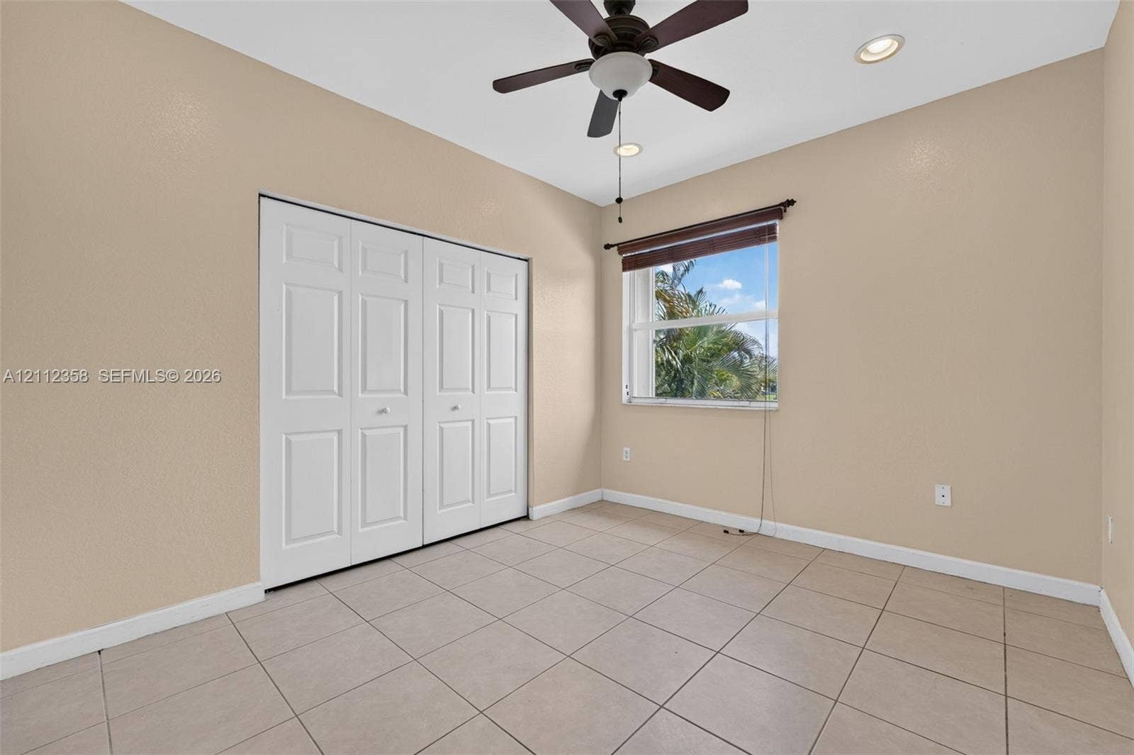 1611 SE 16th Street, Homestead, FL 33035 Room featuring tile flooring, ceiling fan with integrated lighting, recessed lighting, and double-door closet