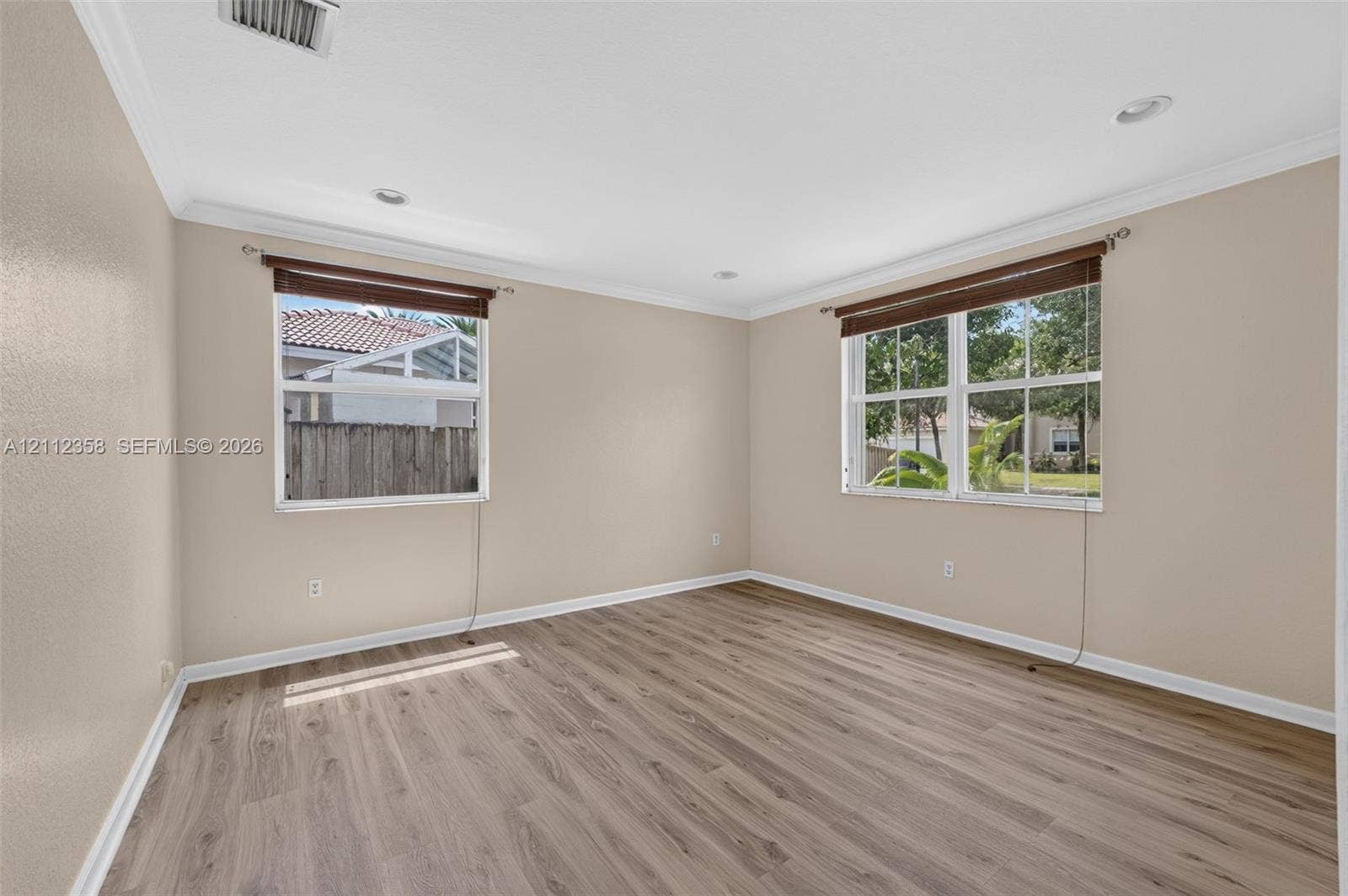 1611 SE 16th Street, Homestead, FL 33035 Neutral interior featuring wood-finish flooring, crown molding, recessed lighting, and multi-pane windows