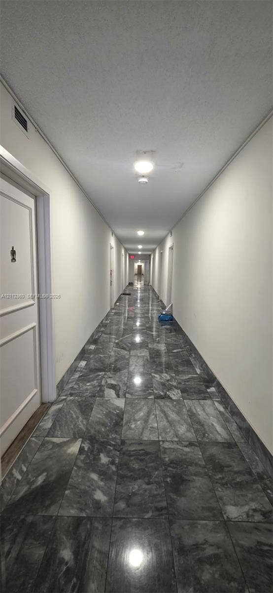Polished stone tile flooring, neutral wall finishes, and recessed ceiling lighting