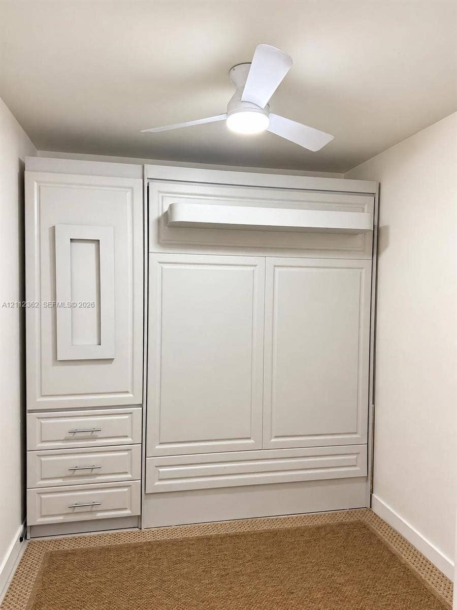 401 N Birch Road, #513, Fort Lauderdale, FL 33304 Built-in wall unit featuring a Murphy bed with storage and desk