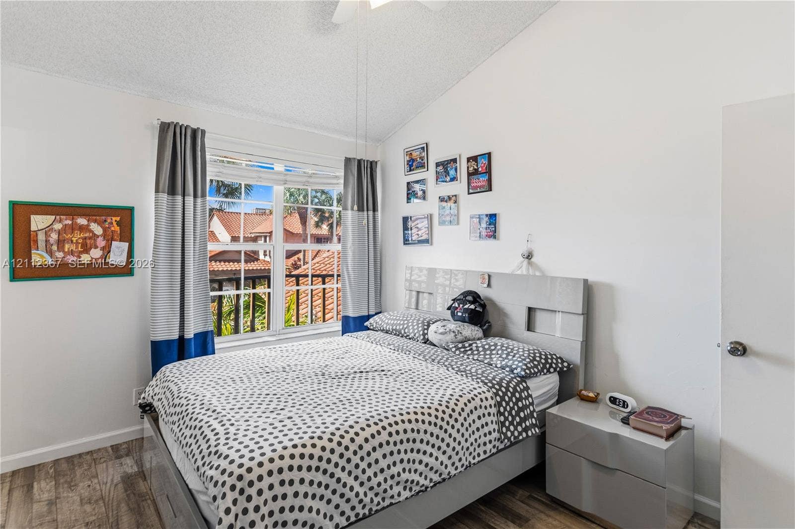 10803 Cypress Glen Drive, #10803, Coral Springs, FL 33071 Vaulted ceiling, wood-finish flooring, multi-pane window, and white interior walls