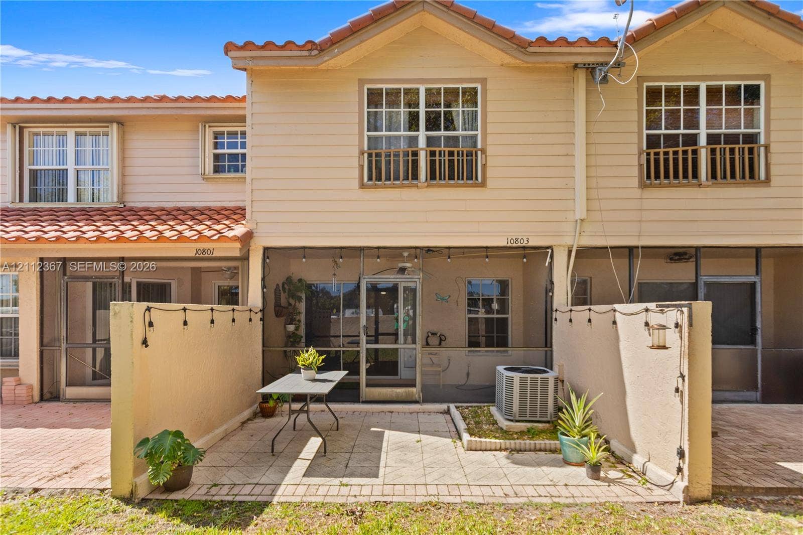 10803 Cypress Glen Drive, #10803, Coral Springs, FL 33071 Two-story residence featuring a tile roof, lap siding, screened-in patio, and paver-stone exterior flooring