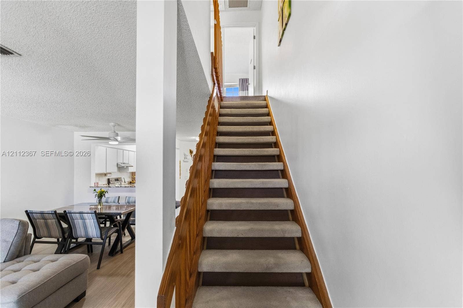 10803 Cypress Glen Drive, #10803, Coral Springs, FL 33071 Staircase featuring wood railings and neutral carpeting