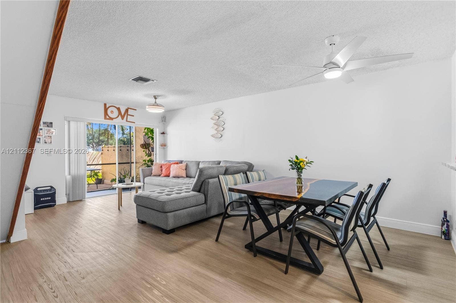 10803 Cypress Glen Drive, #10803, Coral Springs, FL 33071 Wood-finish flooring, ceiling-mounted fan with integrated lighting, and sliding glass doors