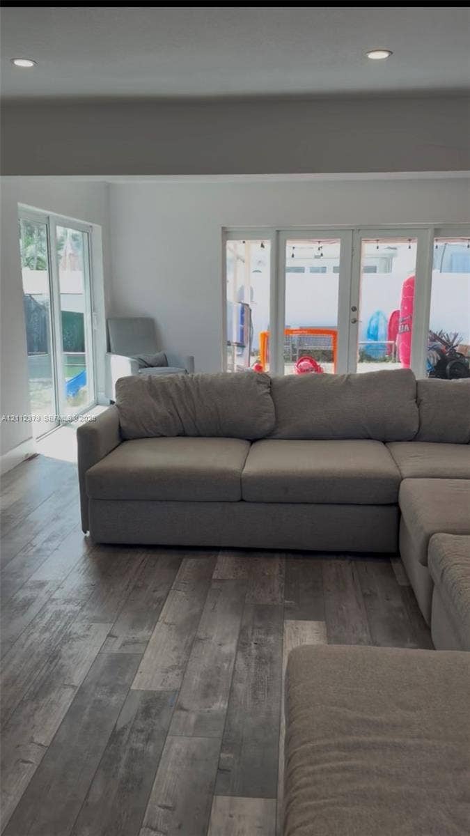 19600 NE 18th Place, Miami, FL 33179 Wood-finish flooring, recessed lighting, and multiple sets of glass-paned doors providing exterior access