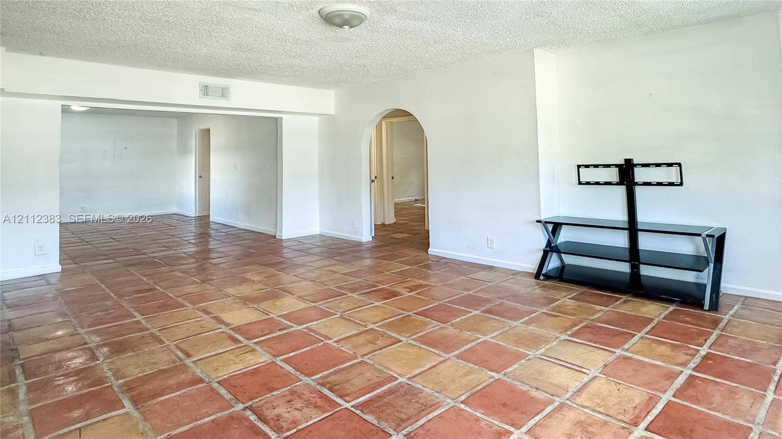 5319 Lake Boulevard, Delray Beach, Delray Beach, FL 33484 Interior space featuring terra cotta tile flooring and an arched entryway