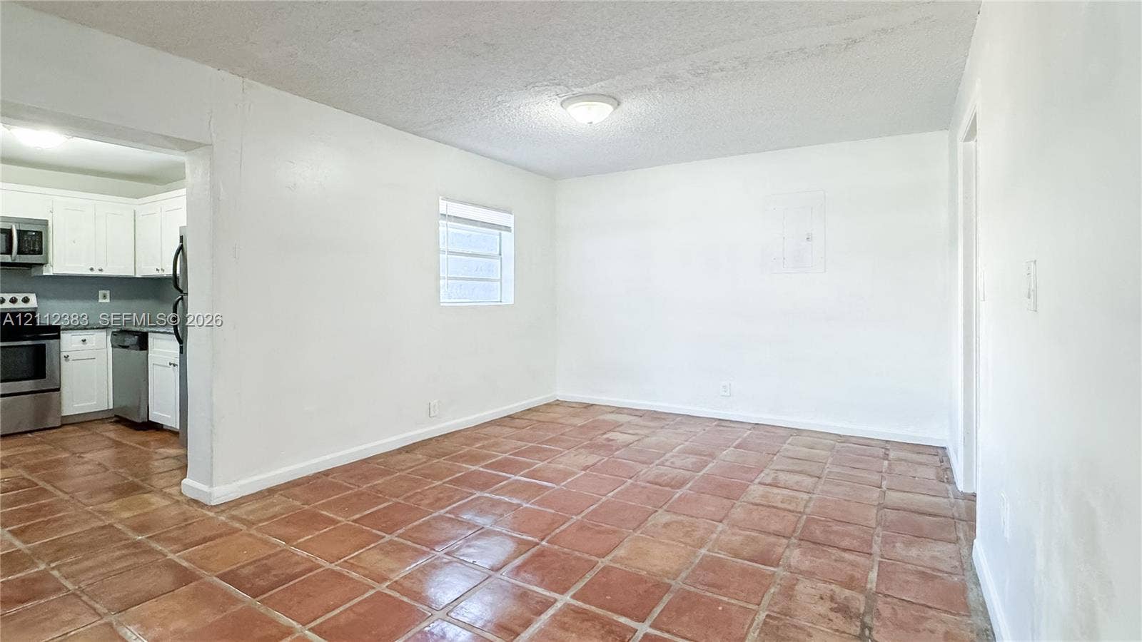 5319 Lake Boulevard, Delray Beach, Delray Beach, FL 33484 Interior space featuring ceramic tile flooring, a flush-mount ceiling light fixture, and a window with blinds