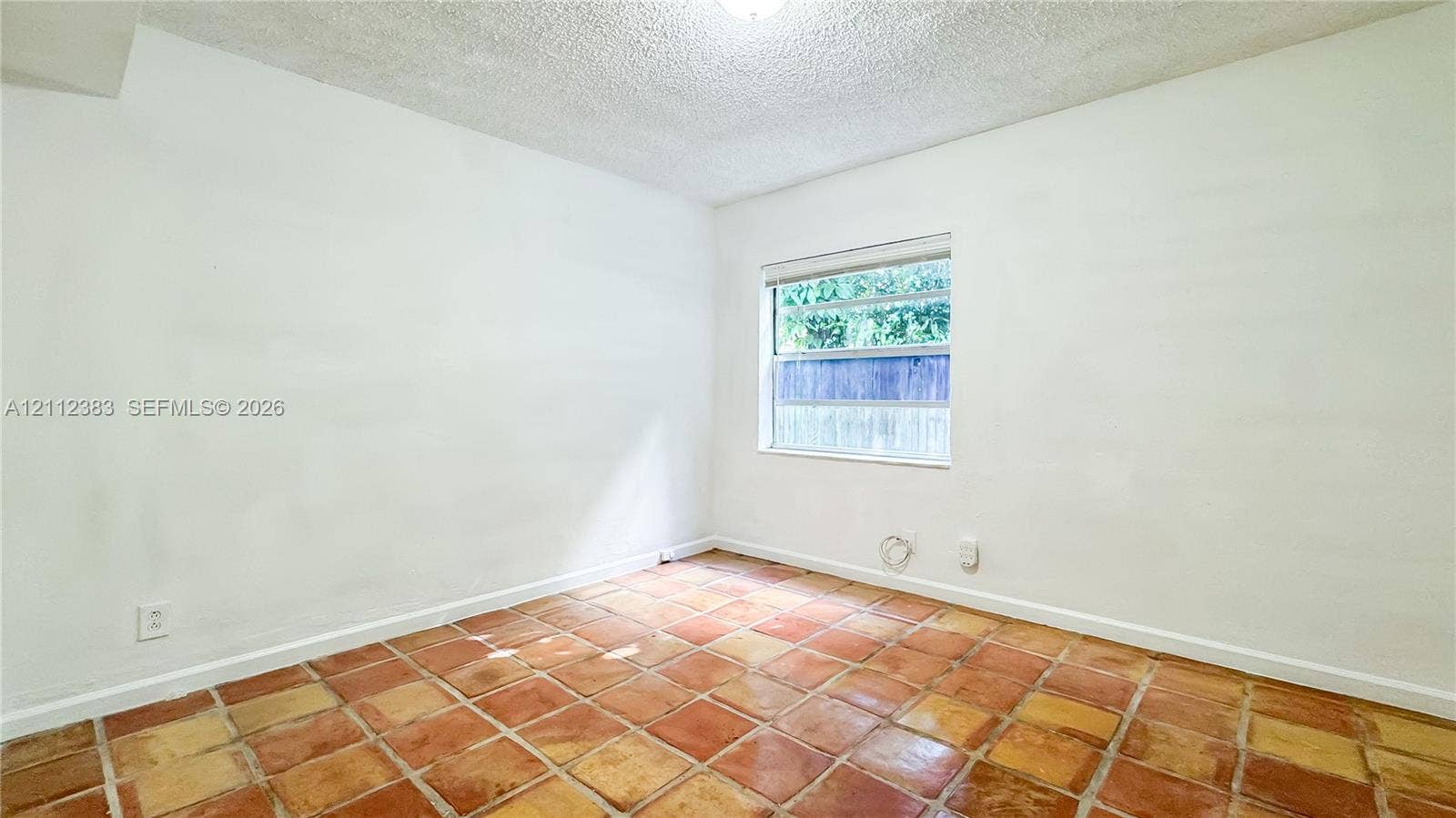 5319 Lake Boulevard, Delray Beach, Delray Beach, FL 33484 Interior room featuring textured ceiling, neutral walls, and terracotta-style tile flooring