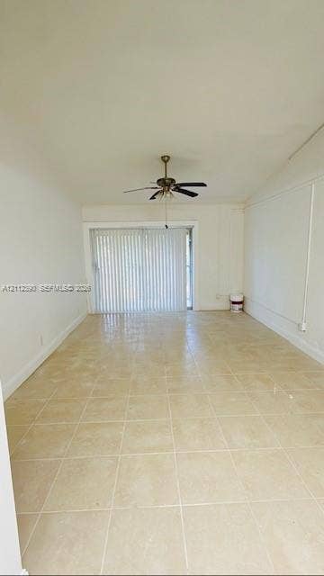 10765 Cleary Boulevard, #305, Plantation, Plantation, FL 33324 Interior space featuring large-format neutral floor tile, a vaulted ceiling, and a central ceiling fan with integrated lighting