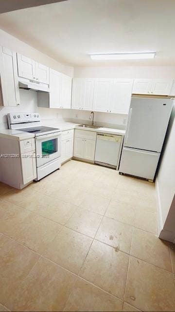 10765 Cleary Boulevard, #305, Plantation, Plantation, FL 33324 Kitchen featuring white cabinetry, solid-surface countertops, tile flooring, and integrated white appliances