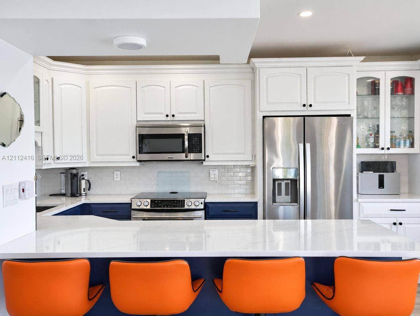 Updated Kitchen featuring new cabinetry, stainless steel appliances, and counter top dining.