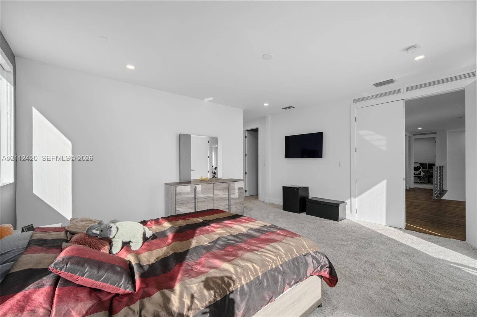 10054 NW 76th Terrace, Doral, FL 33178 Neutral interior featuring recessed lighting, wall-to-wall carpeting, and a large-scale sliding door