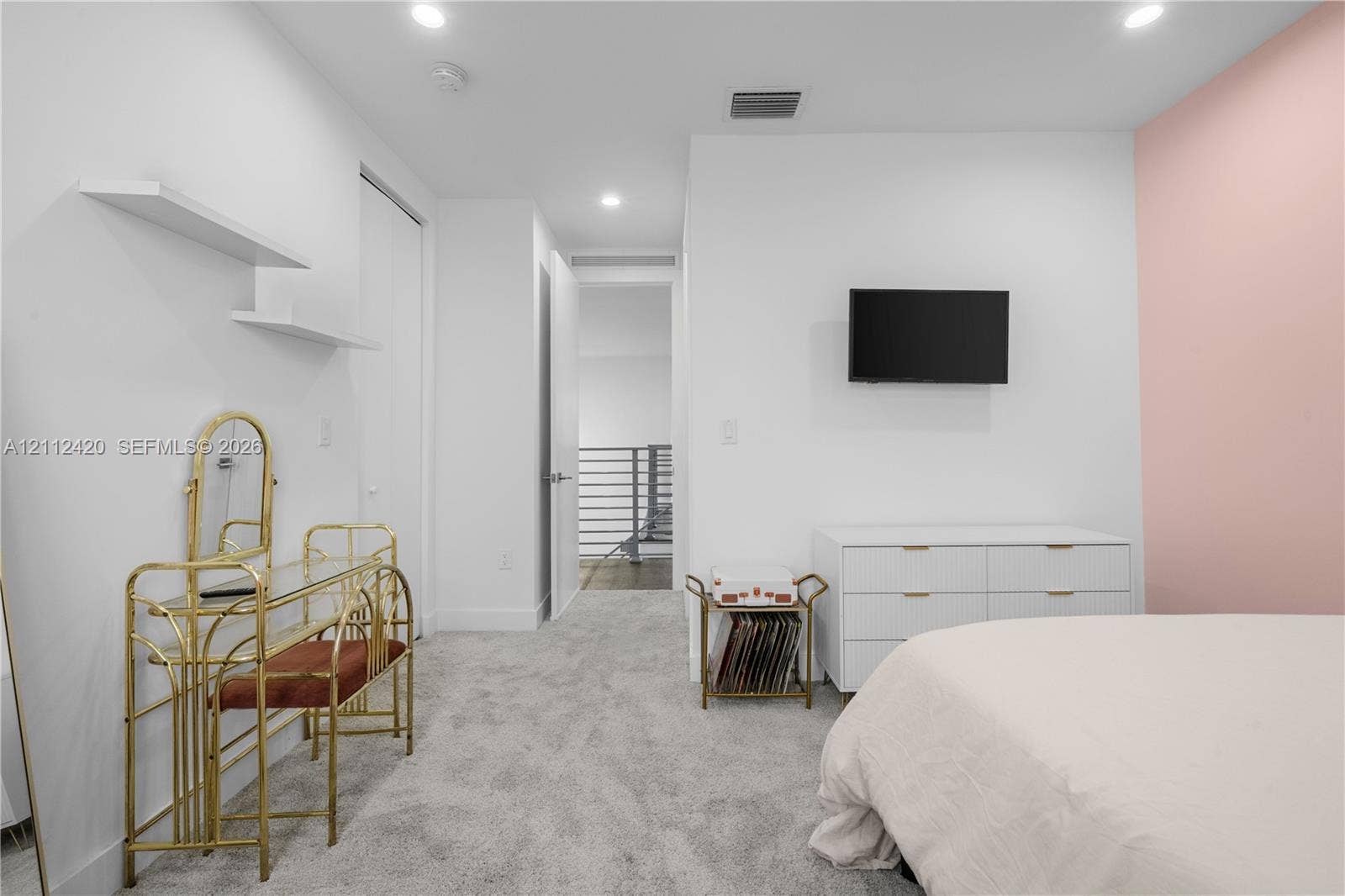 10054 NW 76th Terrace, Doral, FL 33178 Neutral interior featuring wall-to-wall carpeting, recessed ceiling lighting, dual floating wall shelves, and a single-wall accent color