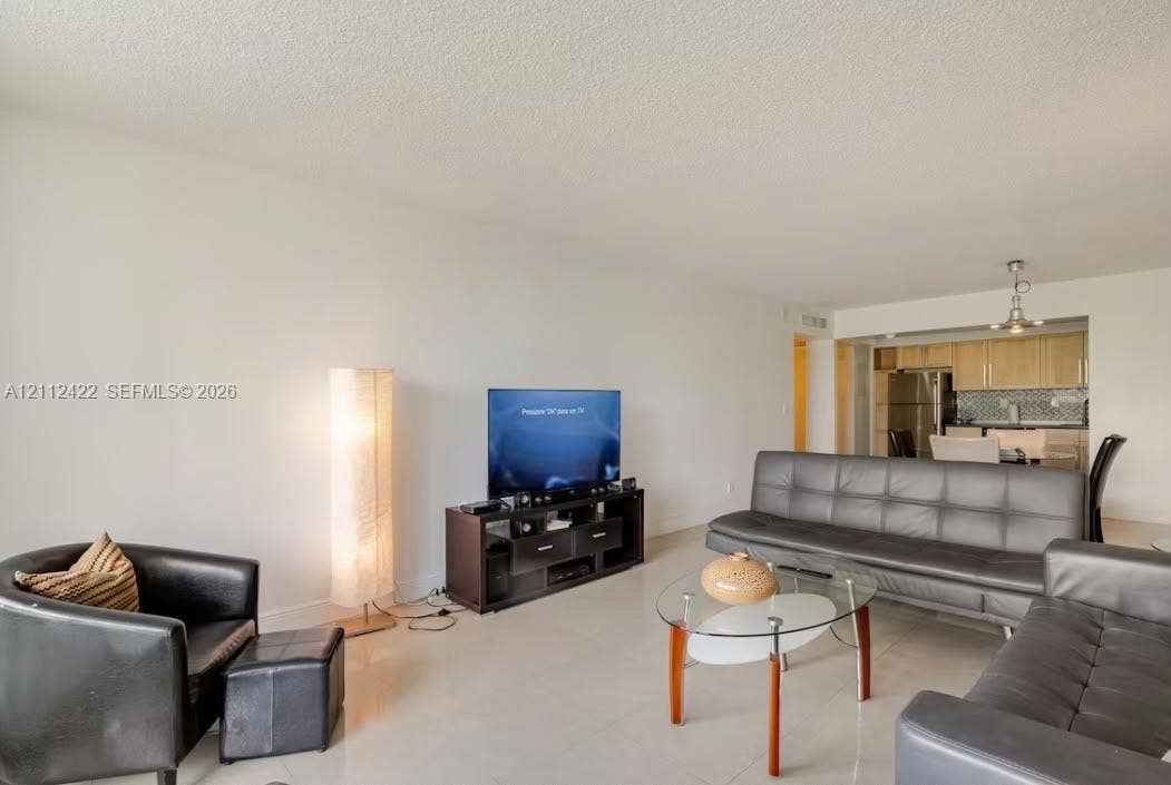 Open-concept interior featuring light-colored tile flooring and a neutral color palette