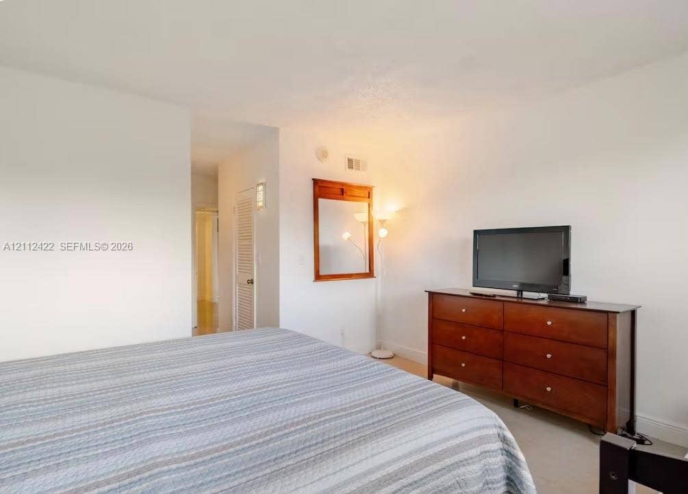Wall-mounted wooden mirror and white-finished walls
