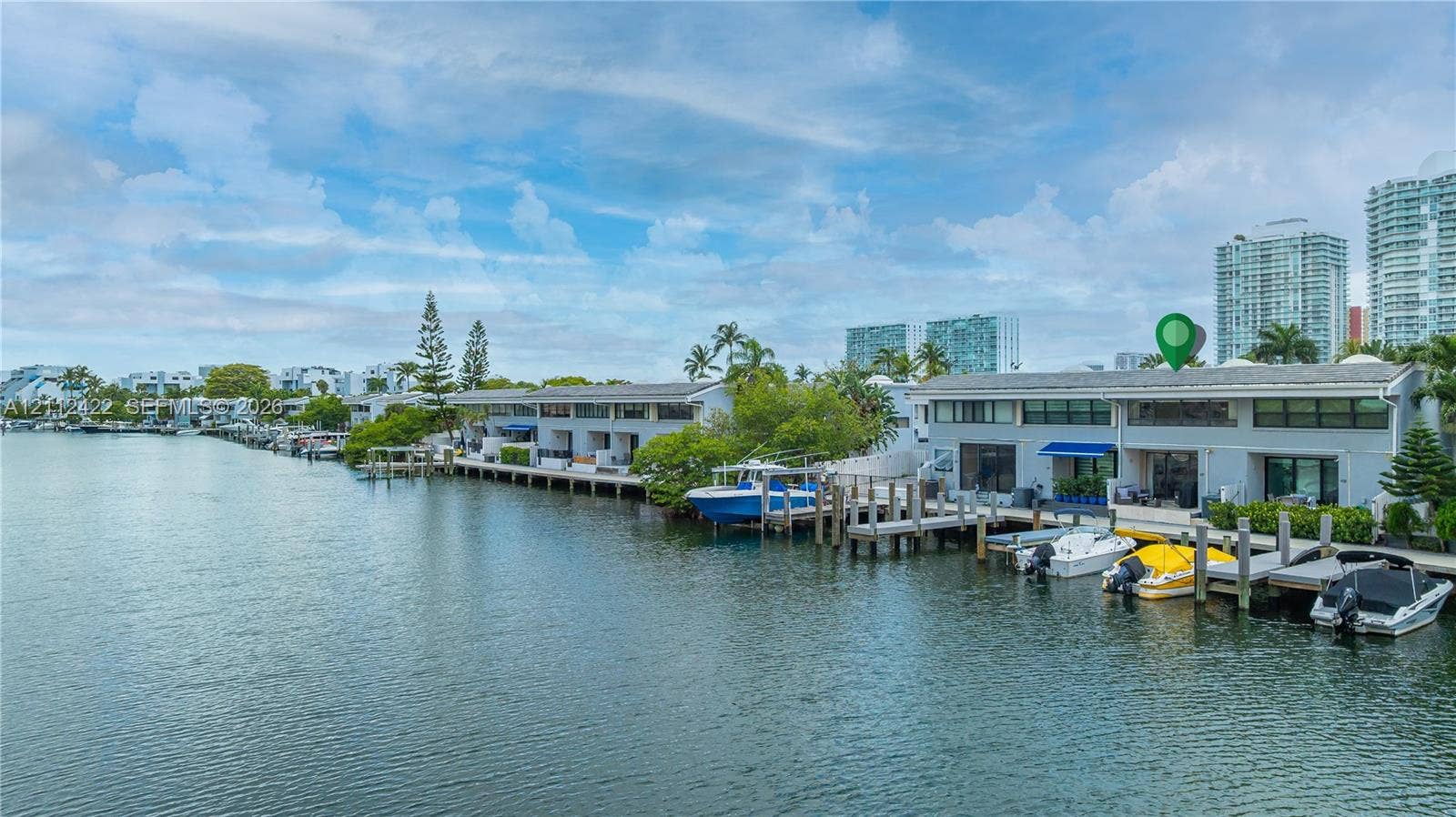 Waterfront property featuring direct canal access, private boat dockage, and multi-level exterior architecture