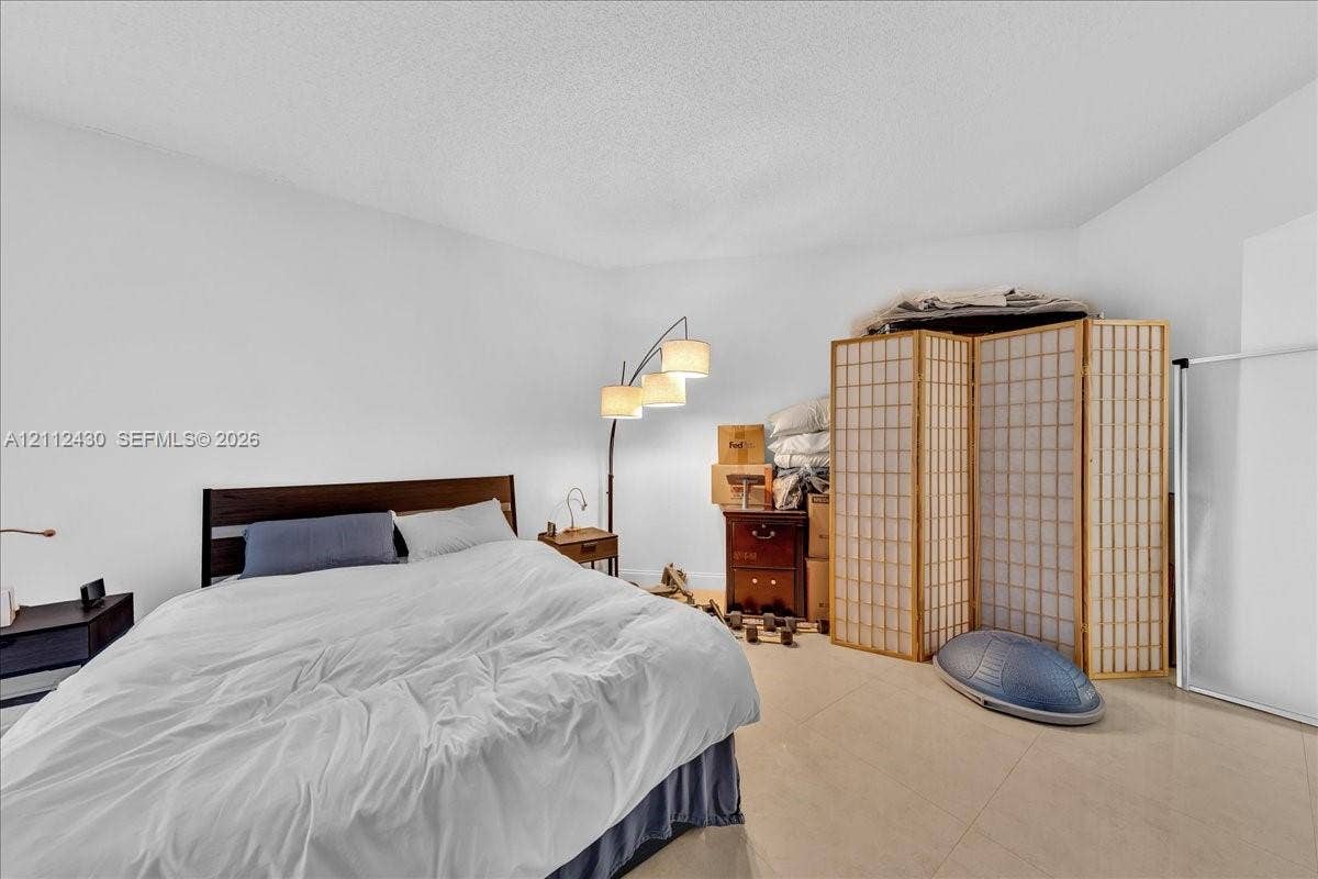 Interior space featuring neutral wall tones and large-format tile flooring
