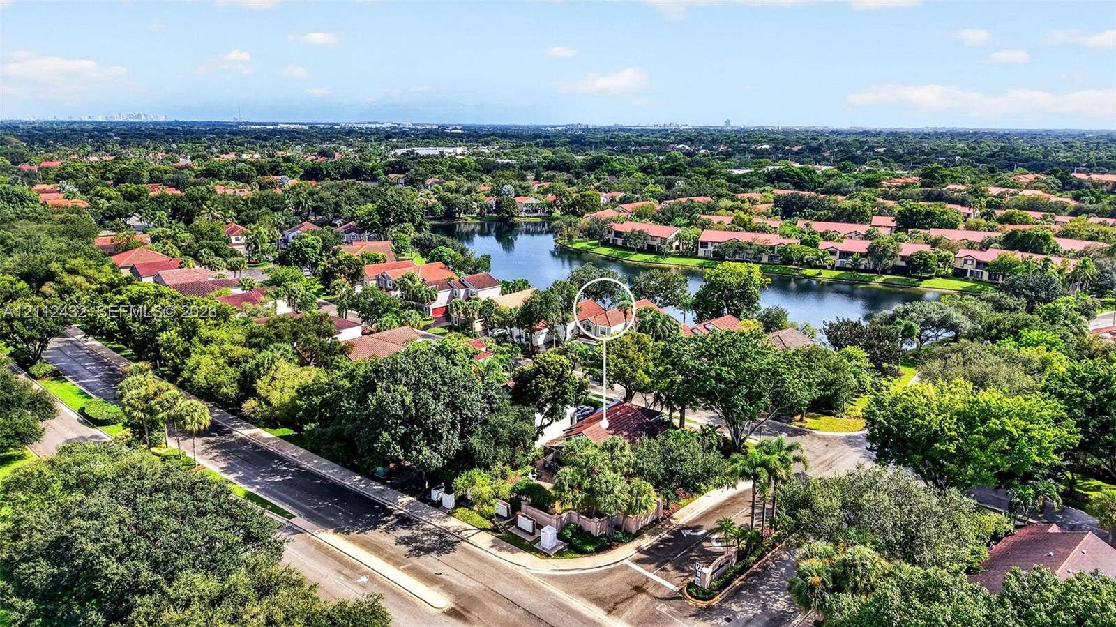 10545 NW 11th Court, Plantation, FL 33322 Aerial perspective of property featuring a tile roof, mature landscaping, and proximity to a neighborhood lake