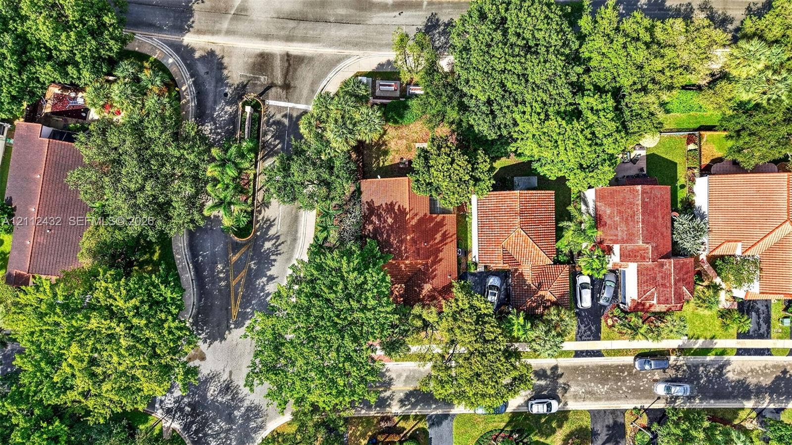 10545 NW 11th Court, Plantation, FL 33322 Aerial perspective of a residential neighborhood featuring mature canopy trees, tiled roofing, paved driveways, and landscaped lawns