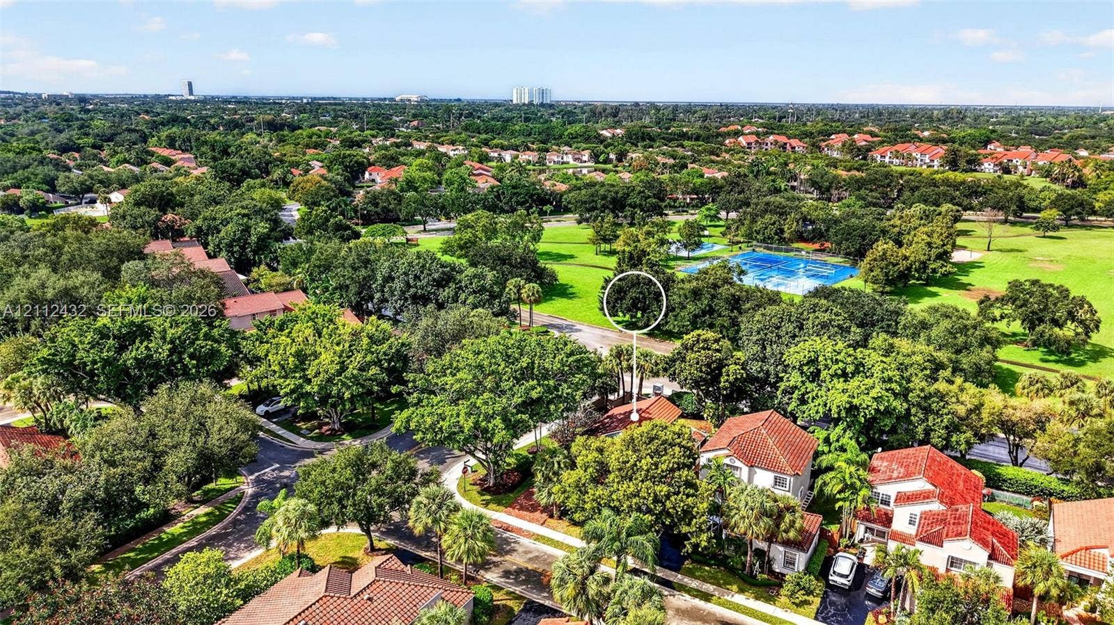 10545 NW 11th Court, Plantation, FL 33322 Aerial perspective showcasing a residential setting with mature tree canopy, tile roof architecture, and proximity to expansive green space