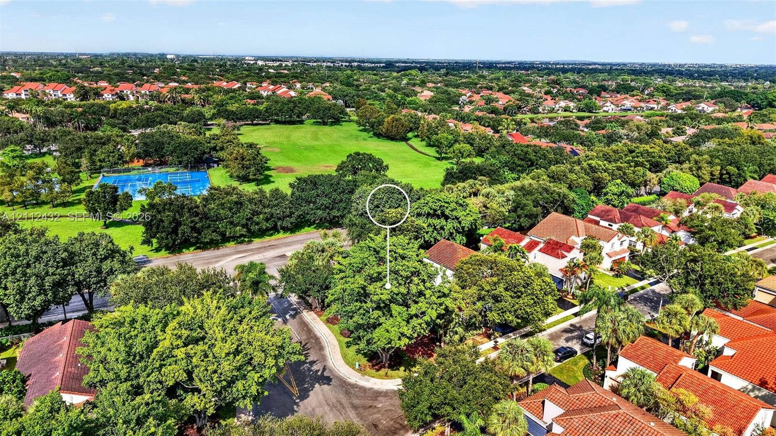 10545 NW 11th Court, Plantation, FL 33322 Aerial perspective of residential property featuring a cul-de-sac location, mature tree canopy, and proximity to expansive green space and recreational courts