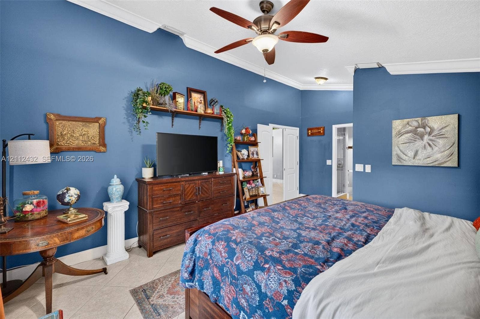 10545 NW 11th Court, Plantation, FL 33322 Vaulted ceilings with crown molding, ceiling fan with light kit, and tile flooring