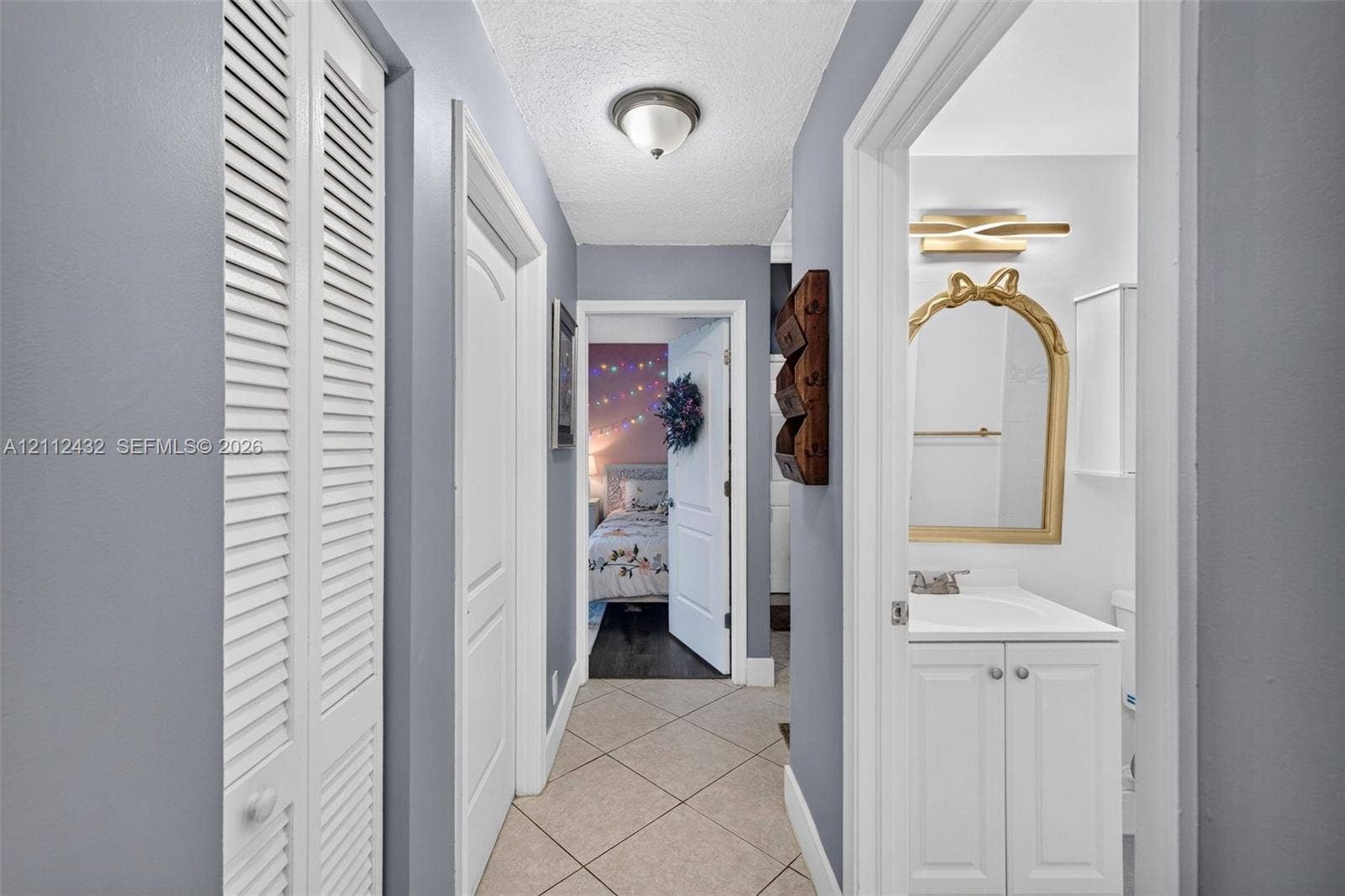 10545 NW 11th Court, Plantation, FL 33322 Hallway featuring diagonal tile flooring, multi-panel interior doors, and closet with louvered doors