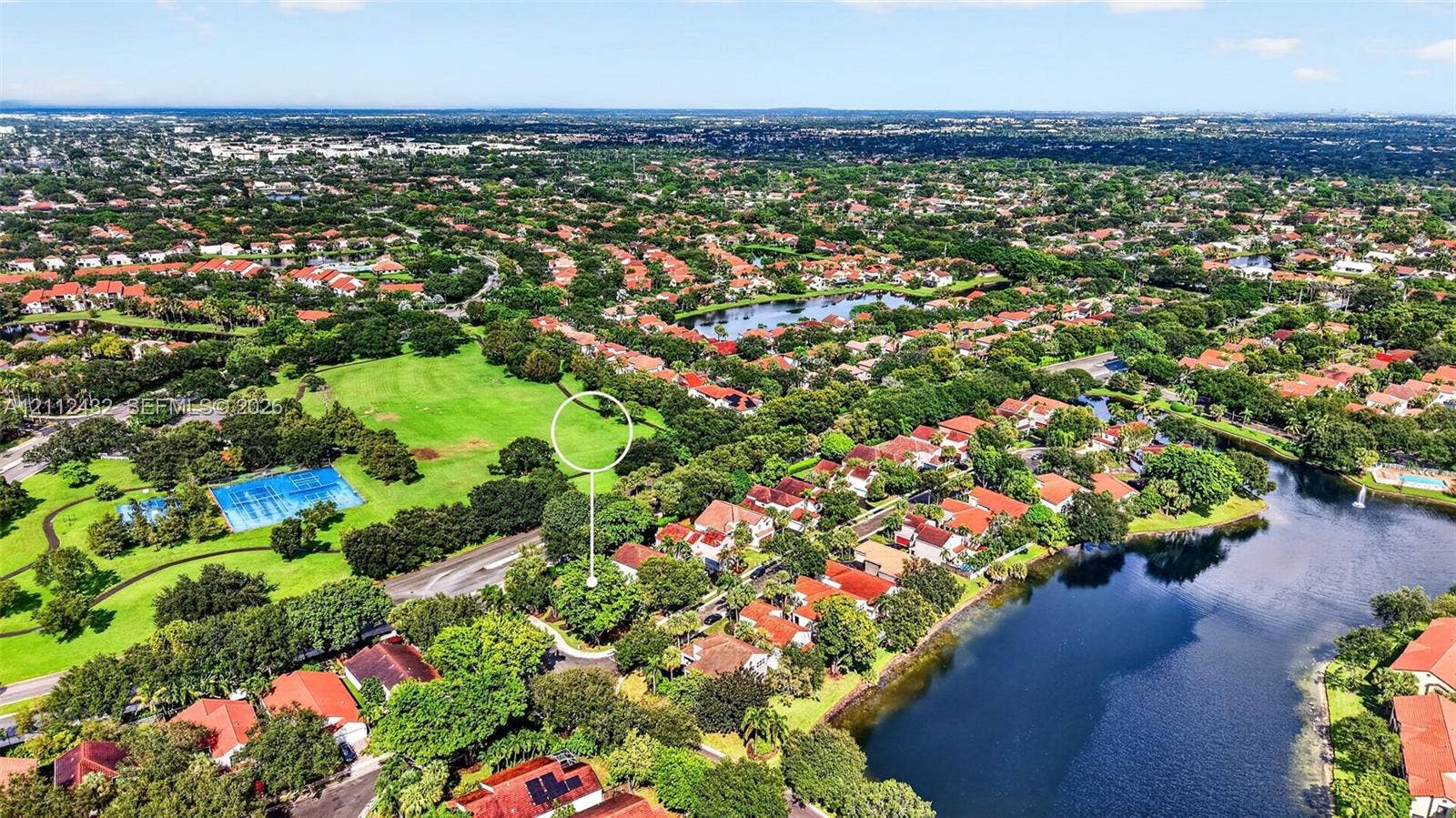 10545 NW 11th Court, Plantation, FL 33322 Aerial perspective of a lot featuring mature trees, positioned near community green space and water features